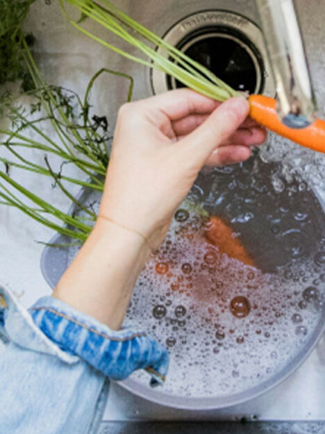 washing vegetables in a sink washing vegetables in a sink