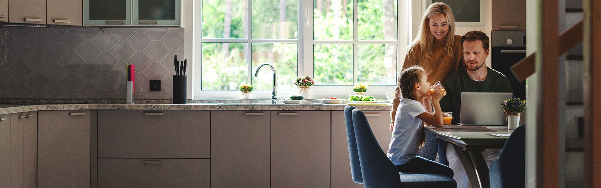 family smiling at sink