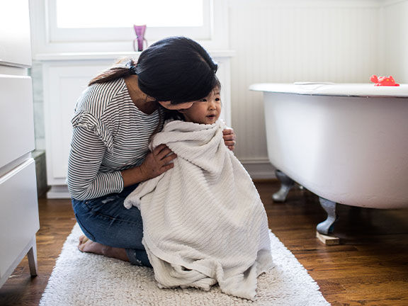 Woman and child getting out of the bath Woman and child getting out of the bath