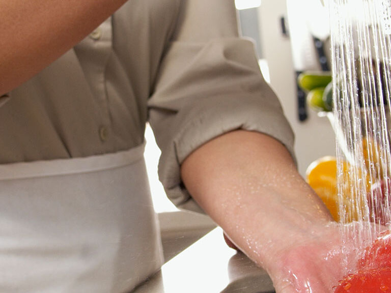 washing vegetables in sink washing vegetables in sink