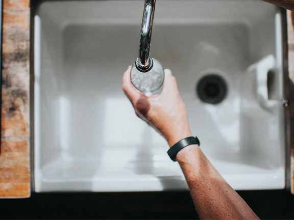 water glass filled in a sink water glass filled in a sink