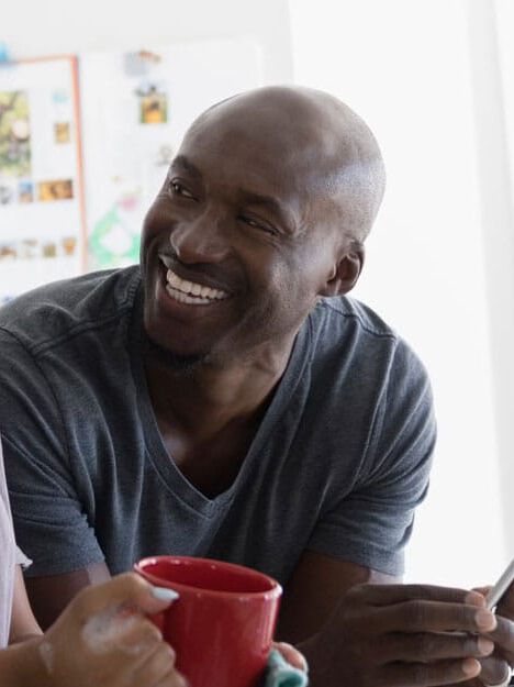 family smiling at sink family smiling at sink
