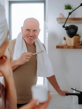 couple getting ready for the day in their bathroom couple getting ready for the day in their bathroom